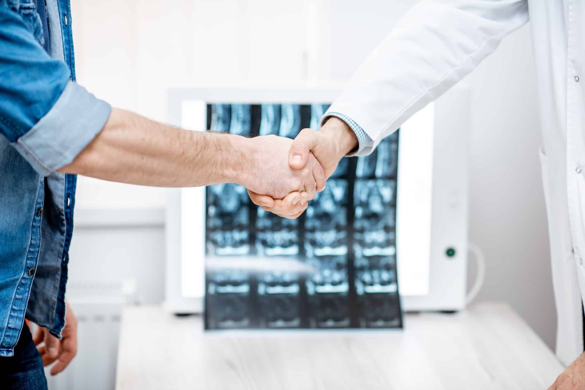 Handshake of the doctor and patient in the office