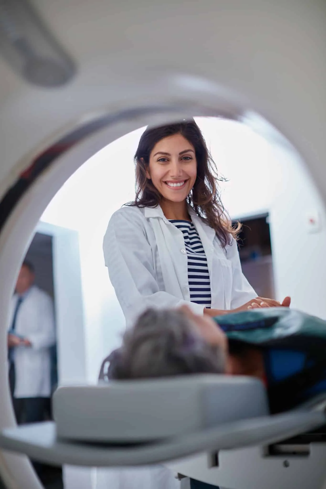 Shot of a mature woman being comforted by a doctor before and MRI scan.