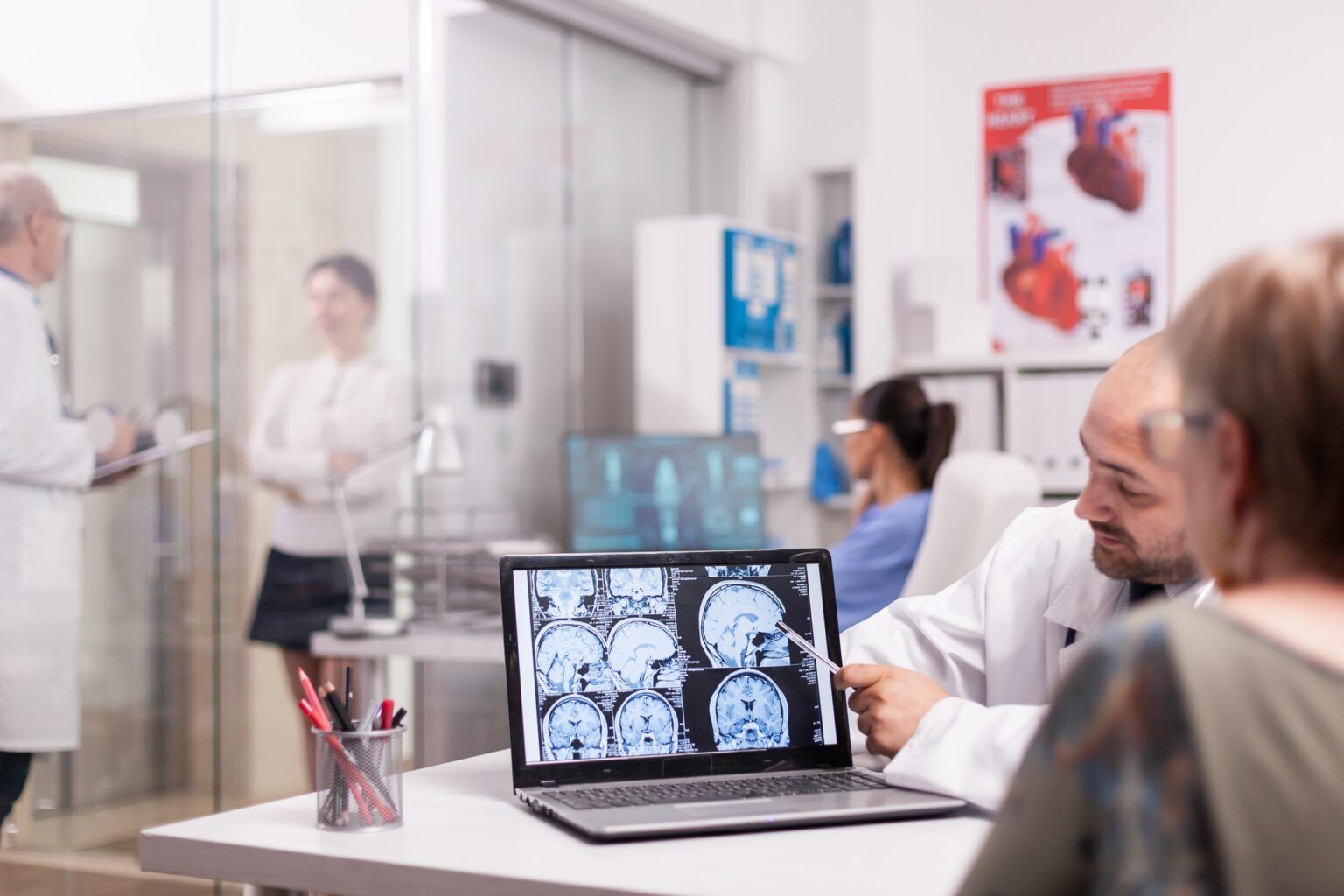 Radiologist pointing at brain ct scan