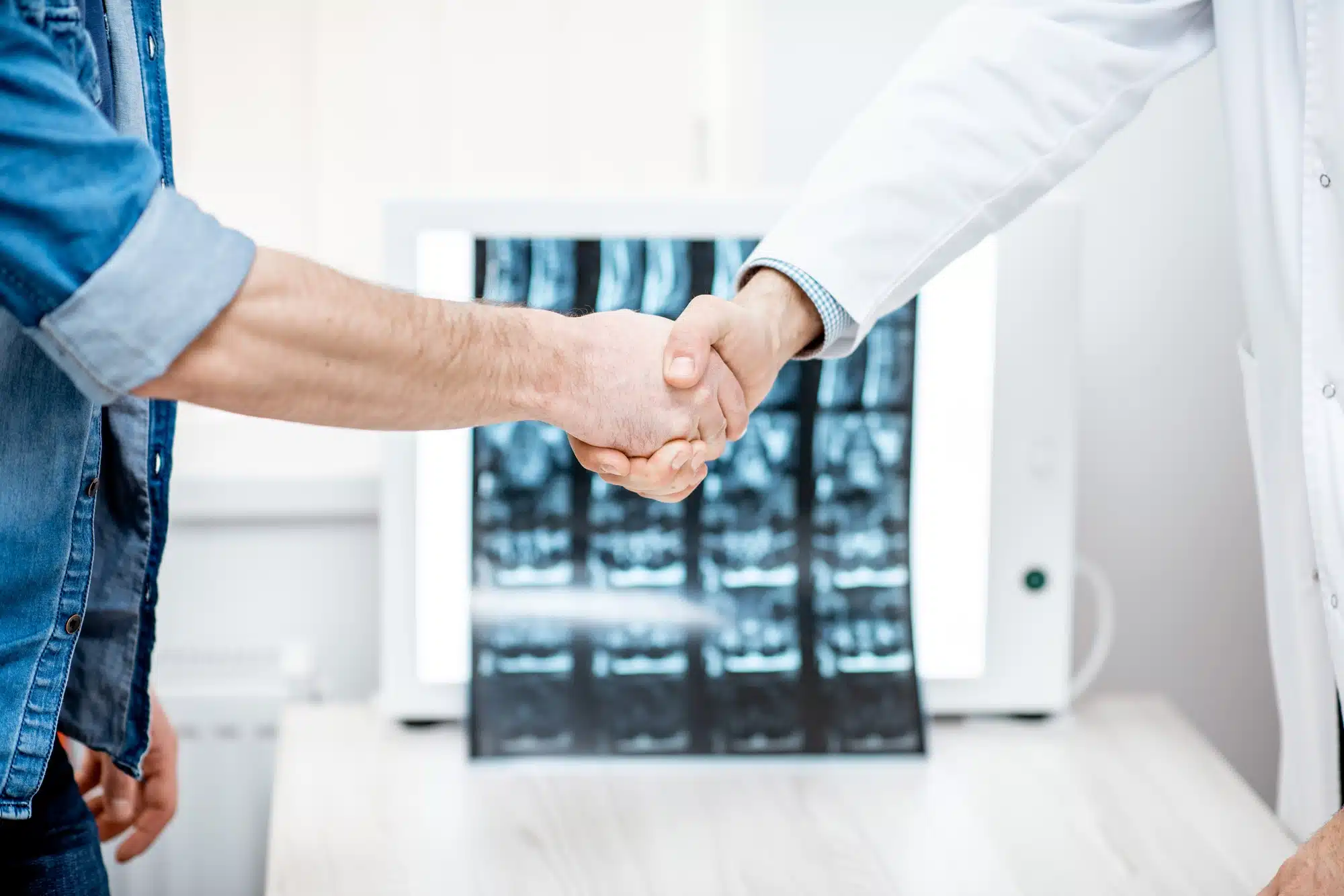 Handshake of the doctor and patient in the office