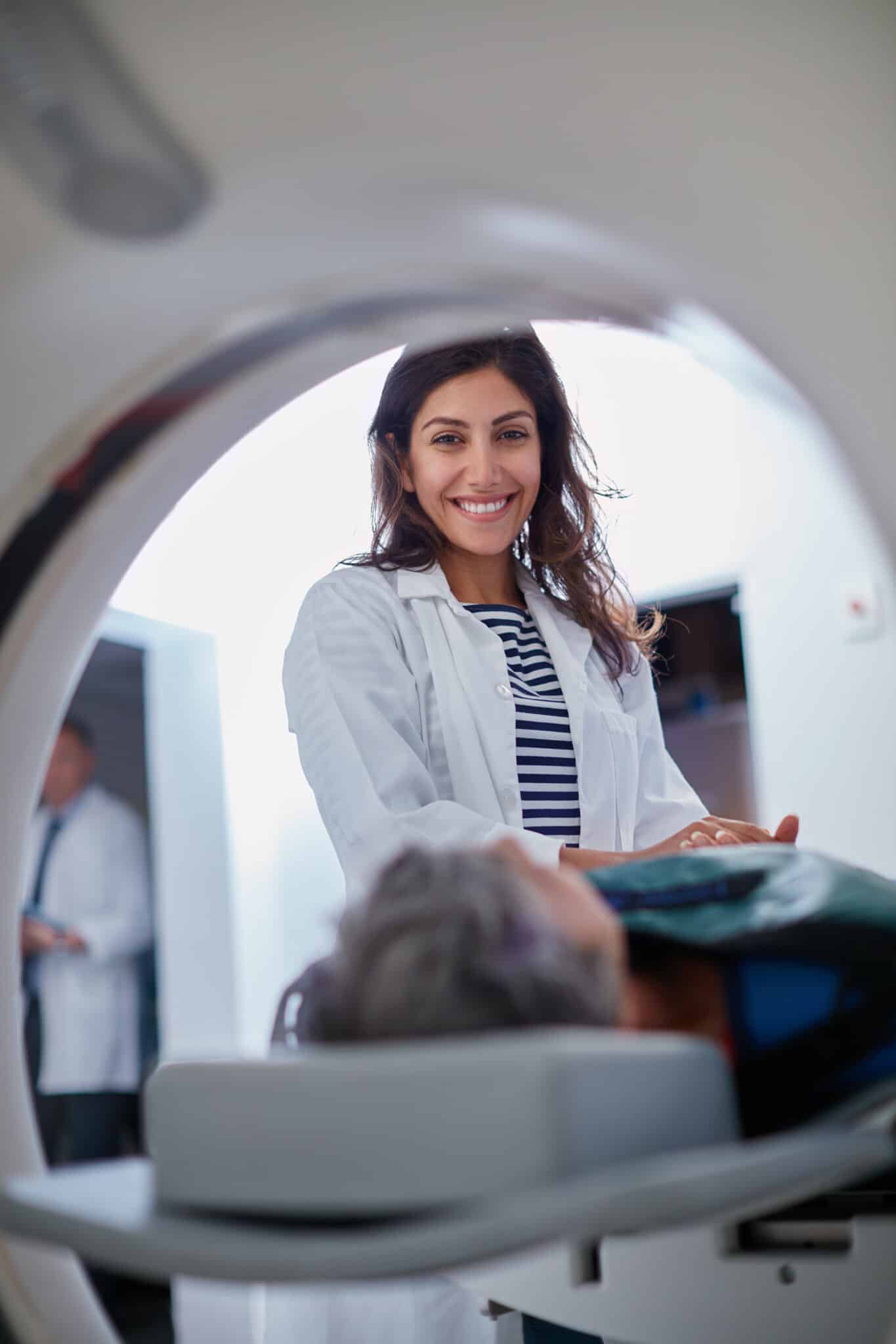 Shot of a mature woman being comforted by a doctor before and MRI scan.